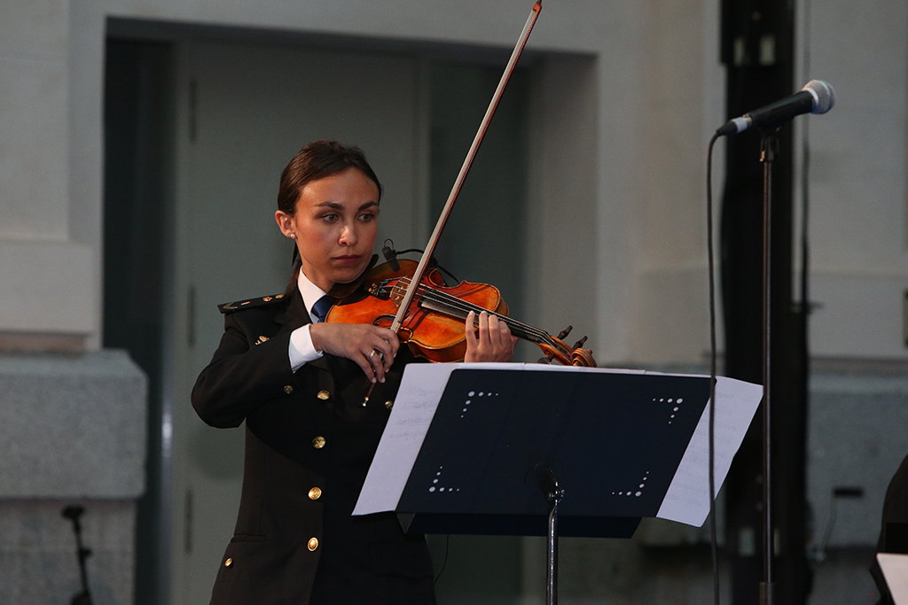 Mujer uniformada tocando el violín en el acto GALA 40 ANIVERSARIO de la incorporación de la mujer a la Policía Nacional.