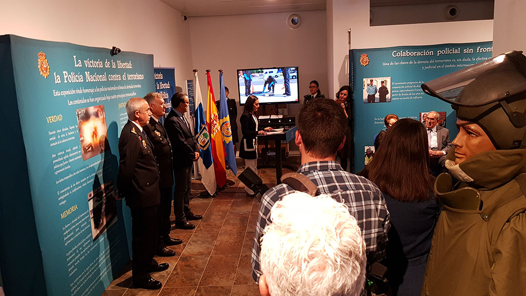 La subdelegada del Gobierno en Huelva en el atril dirigiéndose a autoridades, responsables policiales e invitados en la inauguración de la exposición.